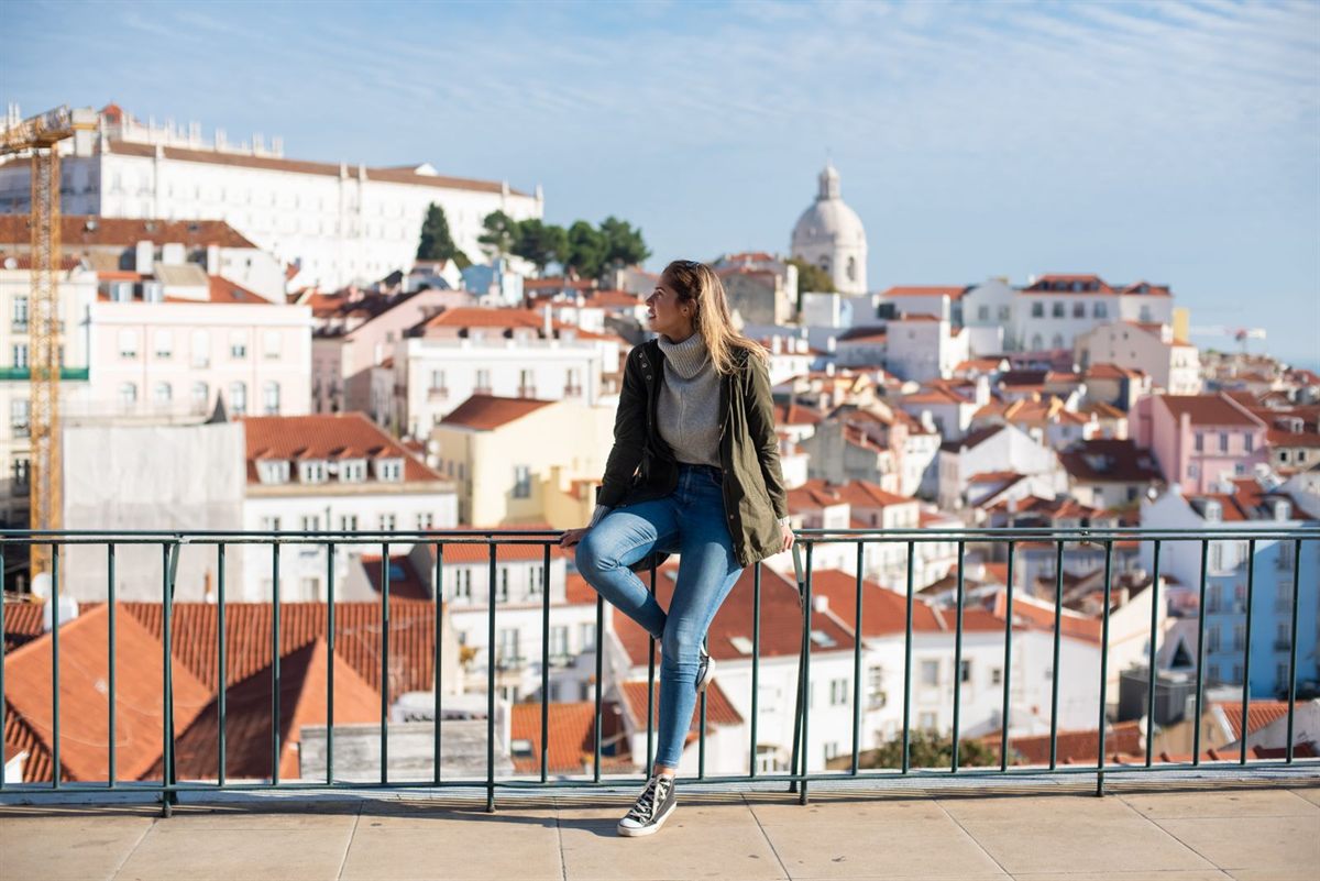 Solo traveler above the rooftops of Lisbon